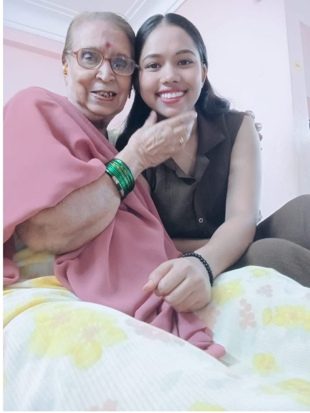 A caregiver spending time with an elderly patient at home